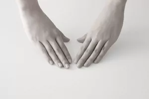 Two hands positioned palm down, prepared to start a skincare routine